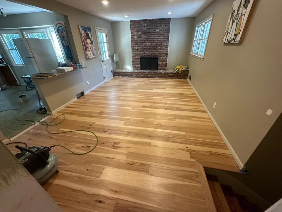Floor sander on a living room floor during a hardwood refinishing job