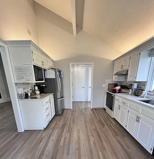 Gray-toned oak floor in a white kitchen