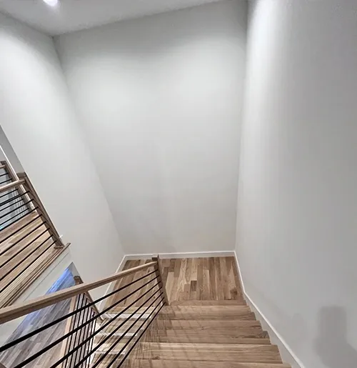 Oak stair treads with a black metal railing